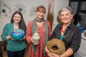 Artists Helen Mccormick, Charline Marzin And Vik Westaway Holding Examples Of Their Work. 